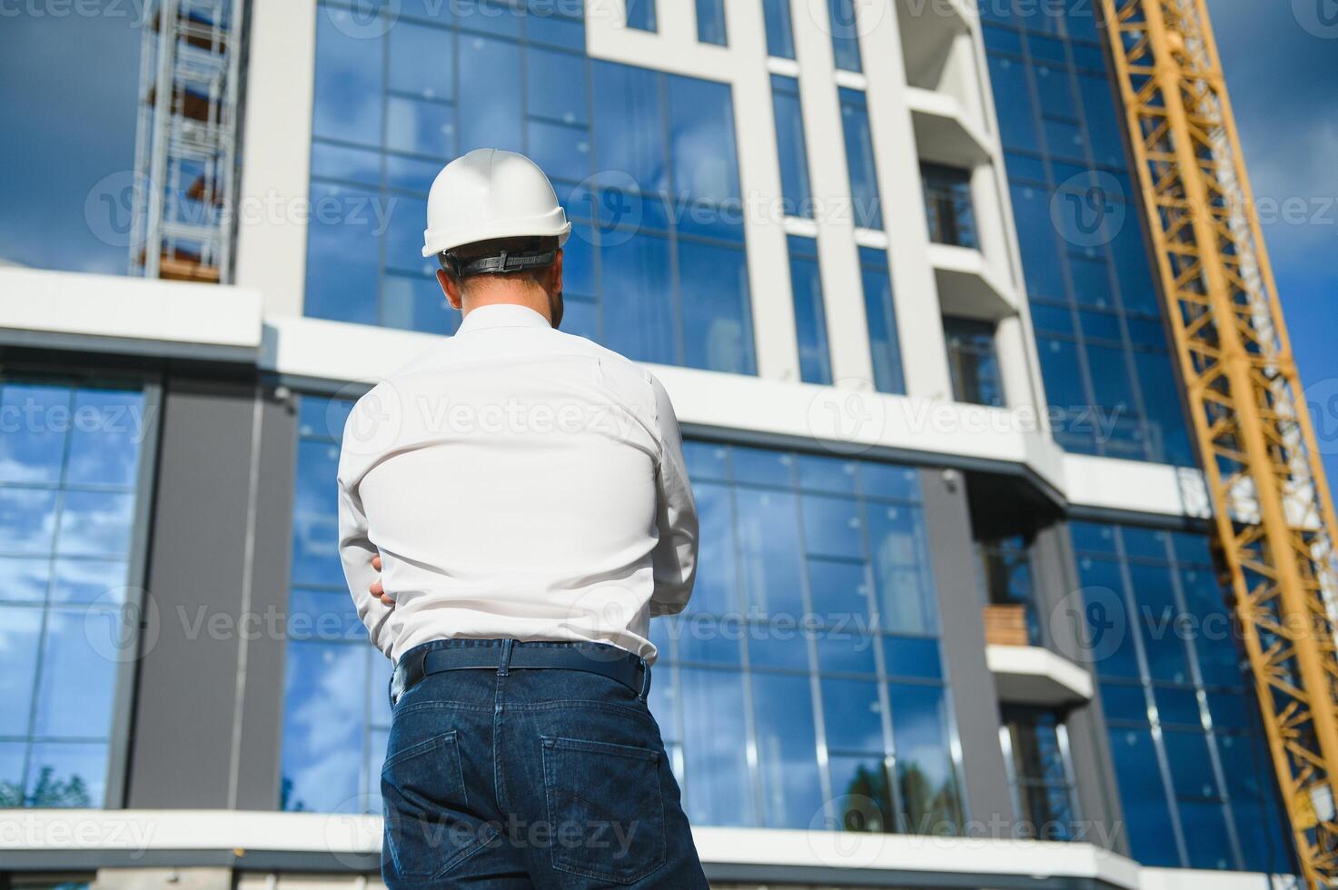 construction worker or architect in construction site outdoors with Hot weather sunny . builder in hard hat inspecting and working in workplace photo