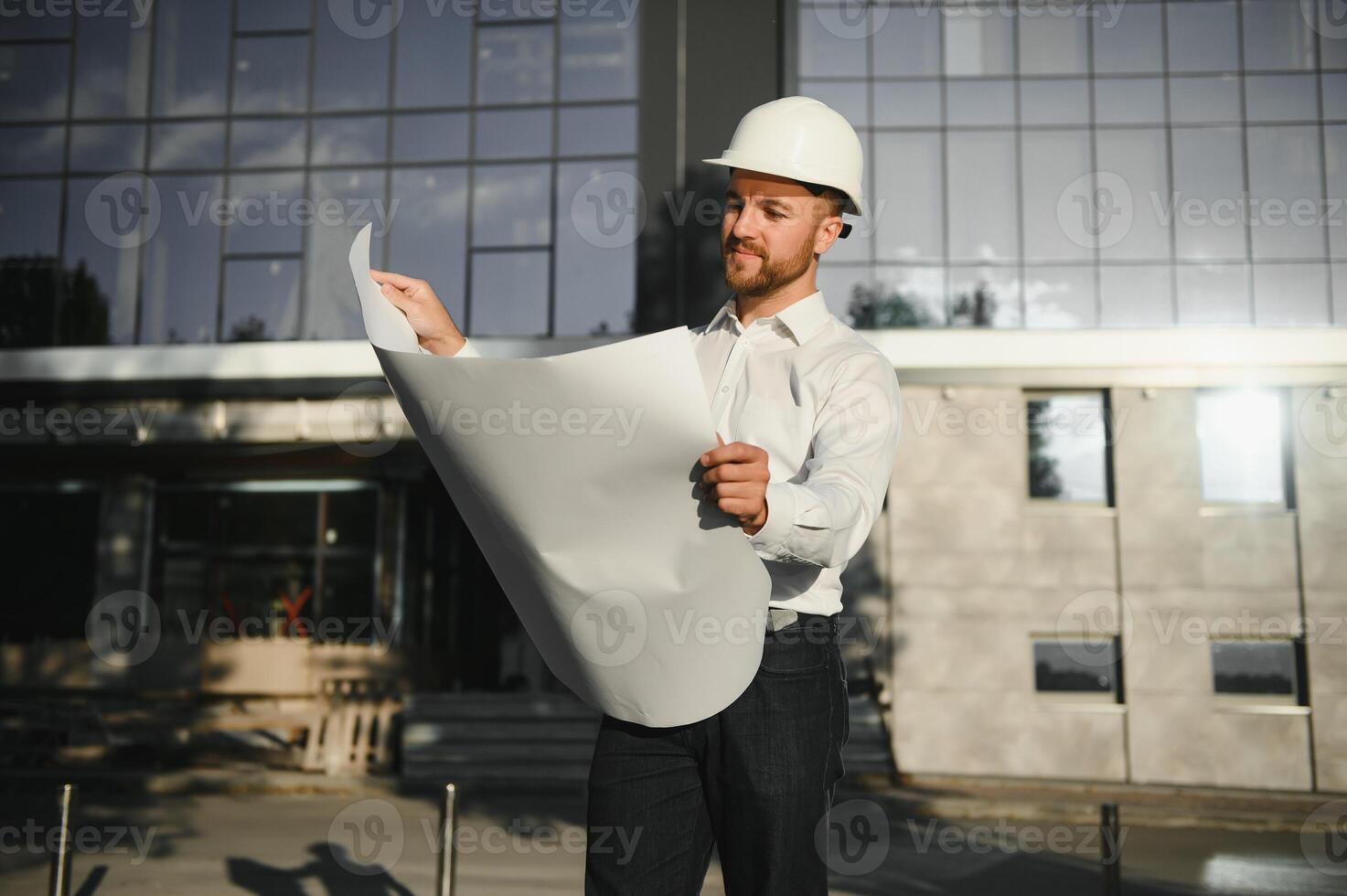 Portrait of a site manager reading a drawing photo
