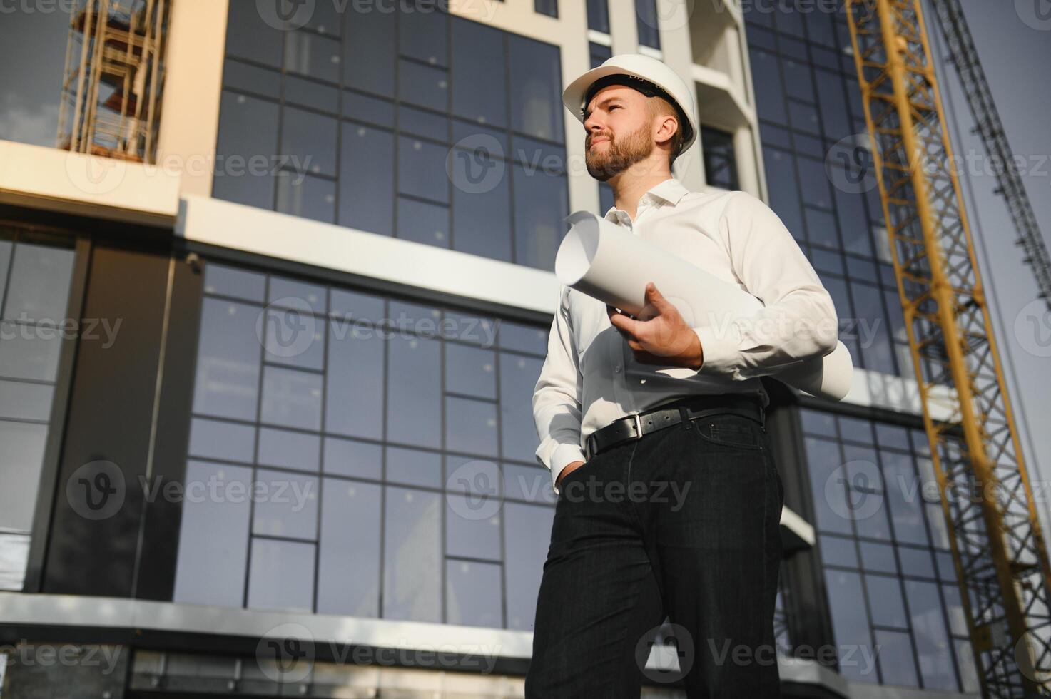 construction worker or architect in construction site outdoors with Hot weather sunny . builder in hard hat inspecting and working in workplace photo