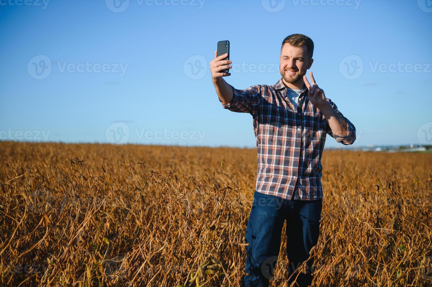 Farmer taking pictures of soybean plantation. Quality control. Agronomist's work. Brazilian Farm. photo