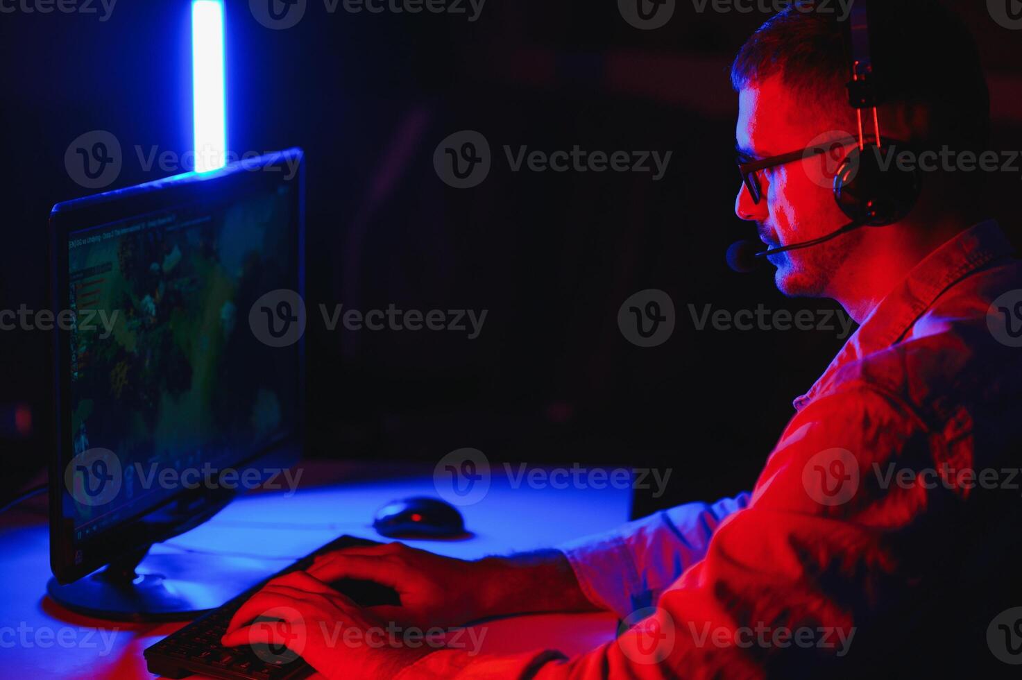 Gamer playing a first person shooter on high end pc. photo