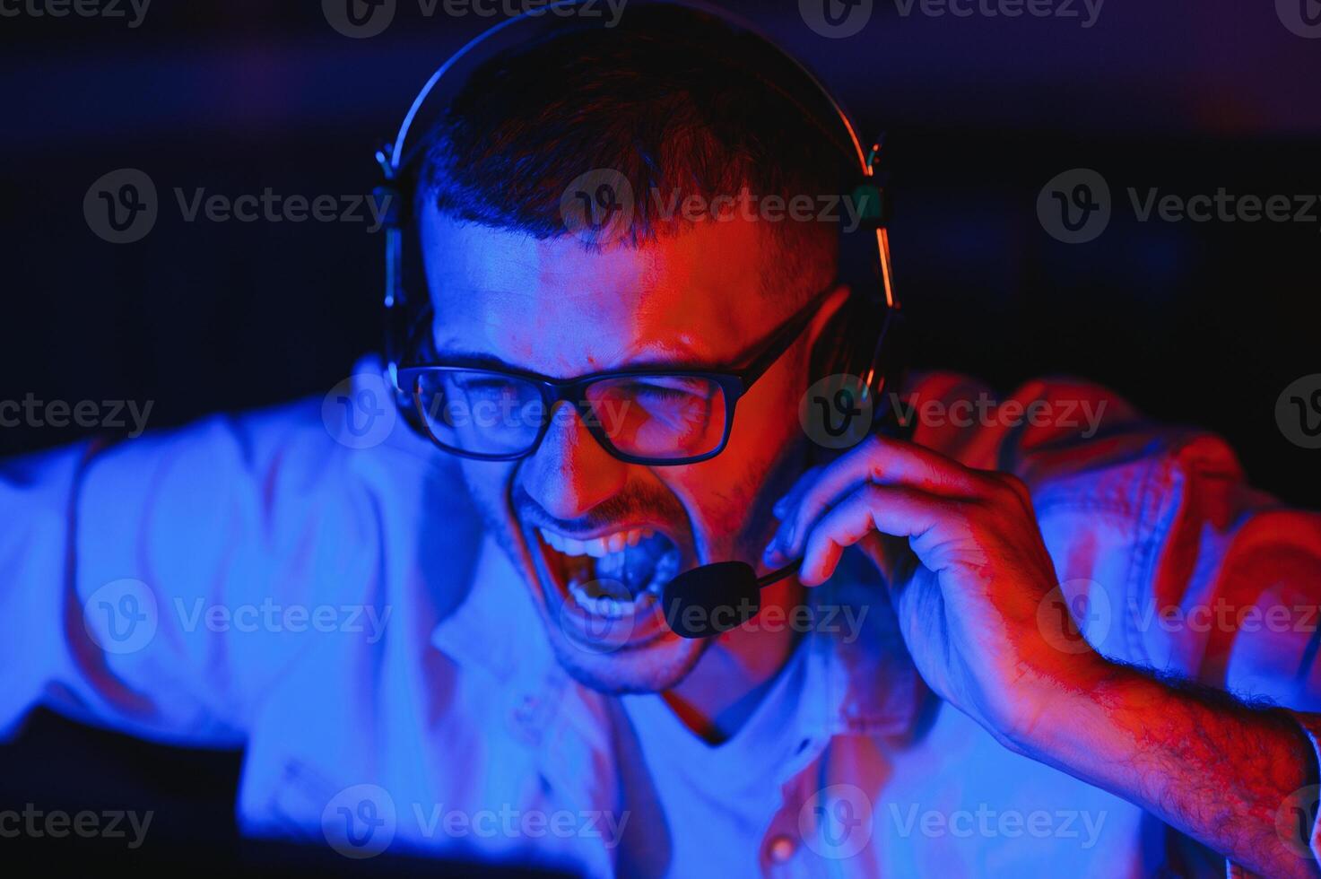 young man playing computer games on line photo
