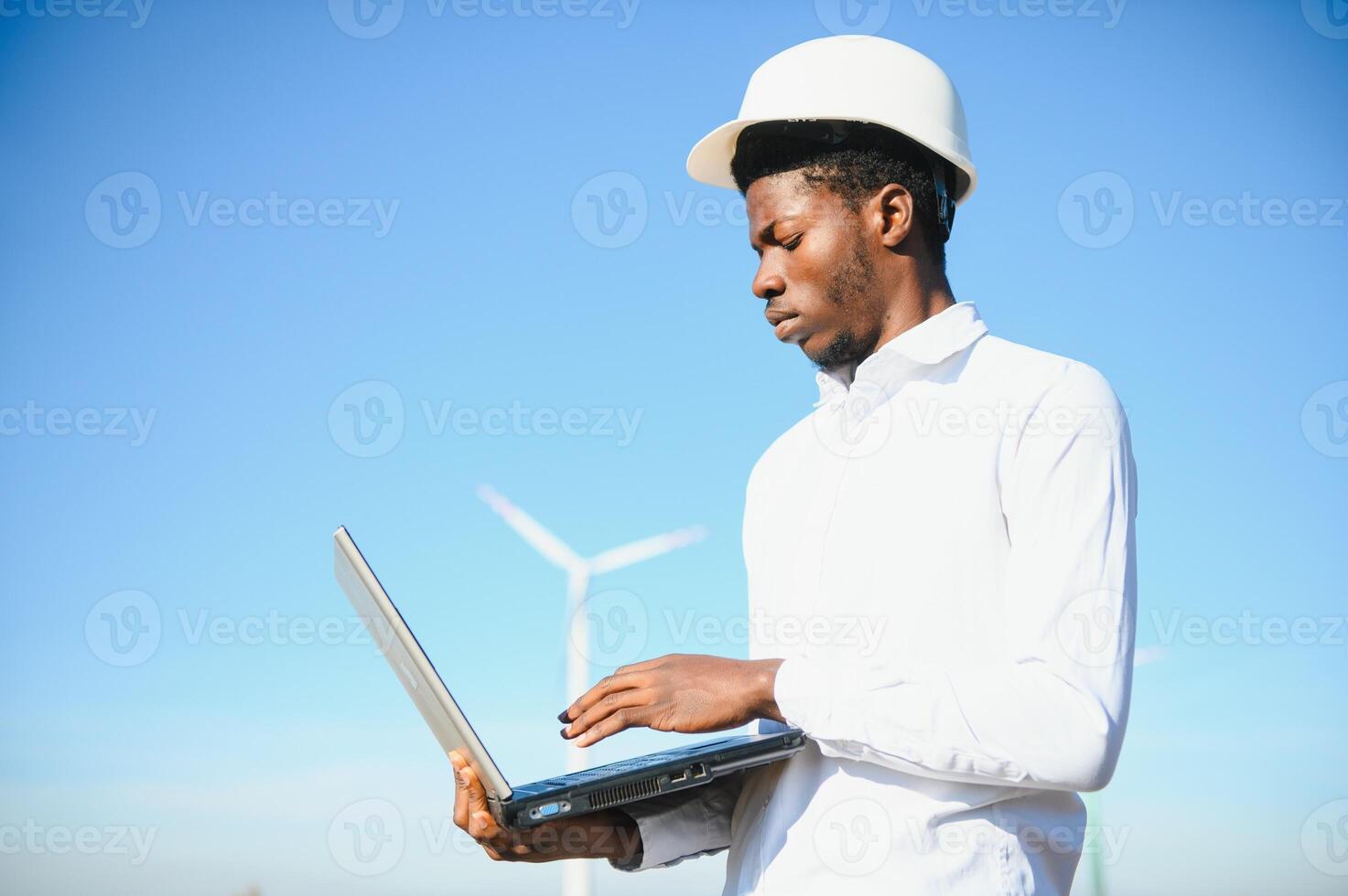 Engineer checks Wind Turbine system with a tablet. Alternative Energy. Wind farm. Clean renewable energy technologies. Wind power plants photo