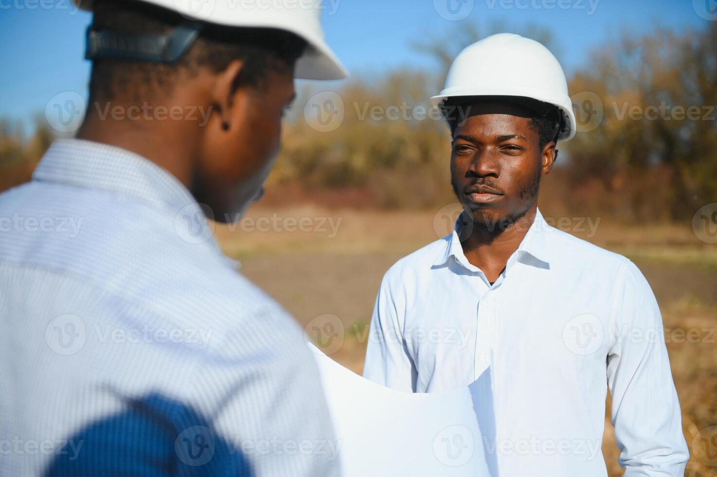 two male surveyors working at mining site photo
