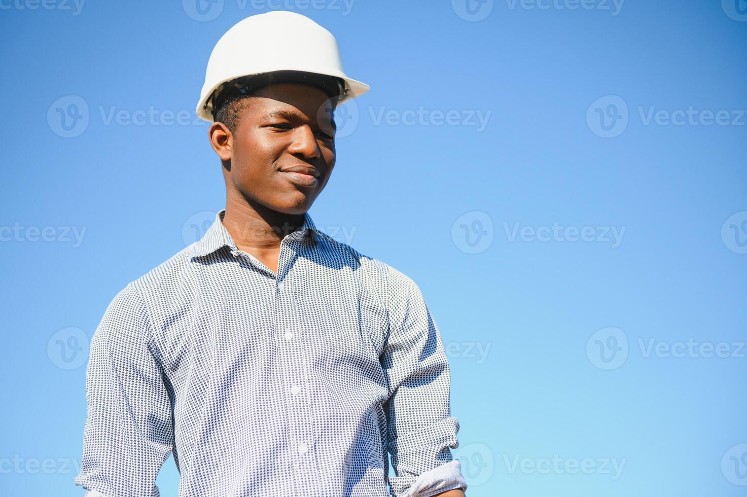 African American worker in a construction helmet photo