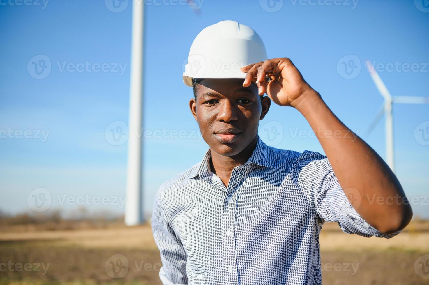 Engineer checks Wind Turbine system with a tablet. Alternative Energy. Wind farm. Clean renewable energy technologies. Wind power plants photo