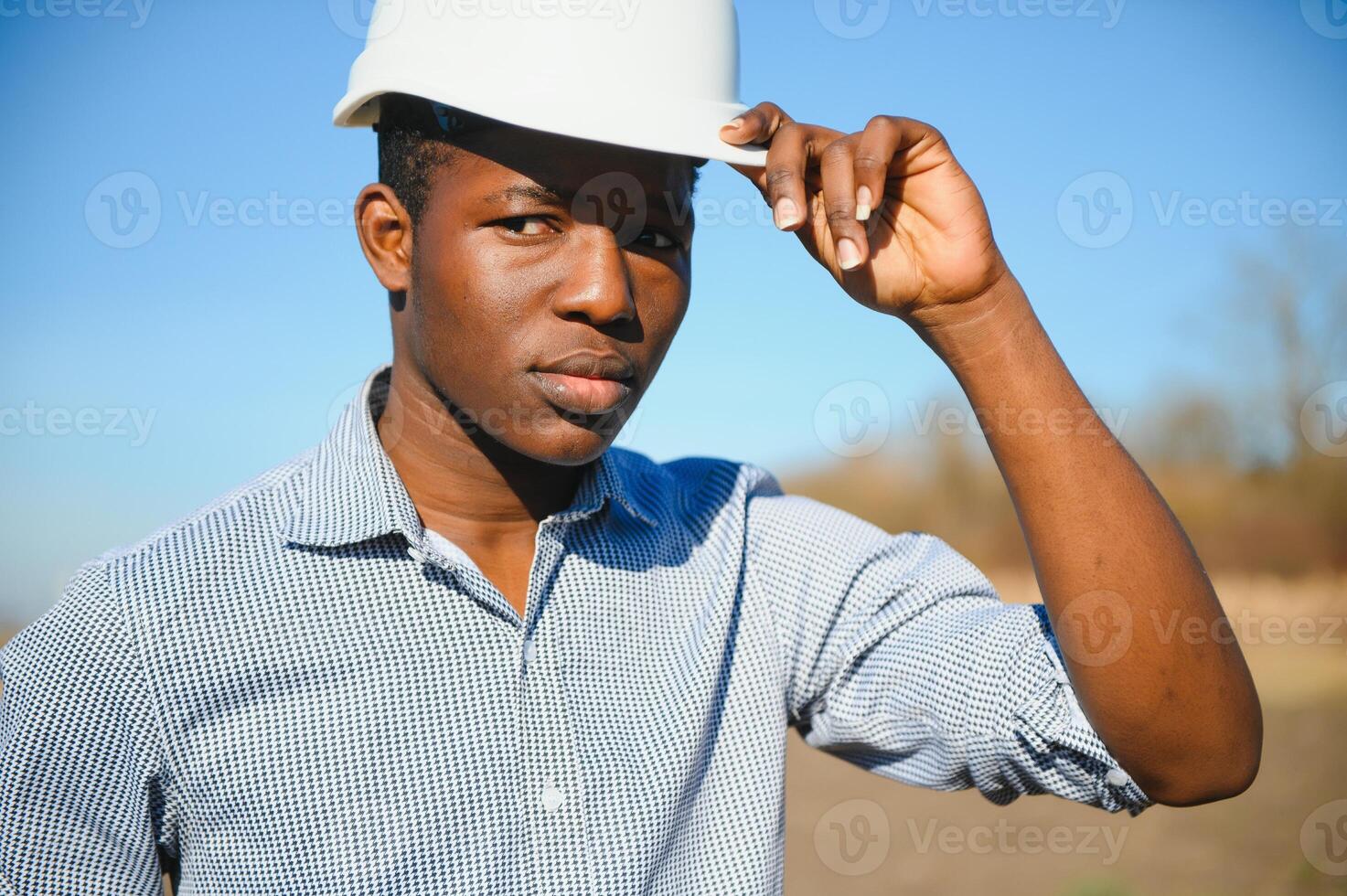 Portrait of happy African construction over with hardhat photo