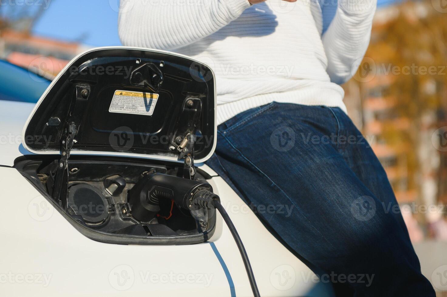 Man turning on charging of car photo