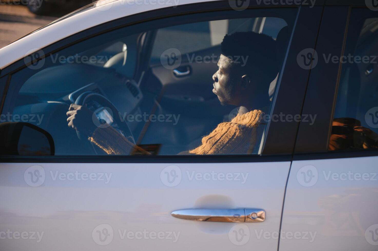 African American driving an electric car. photo