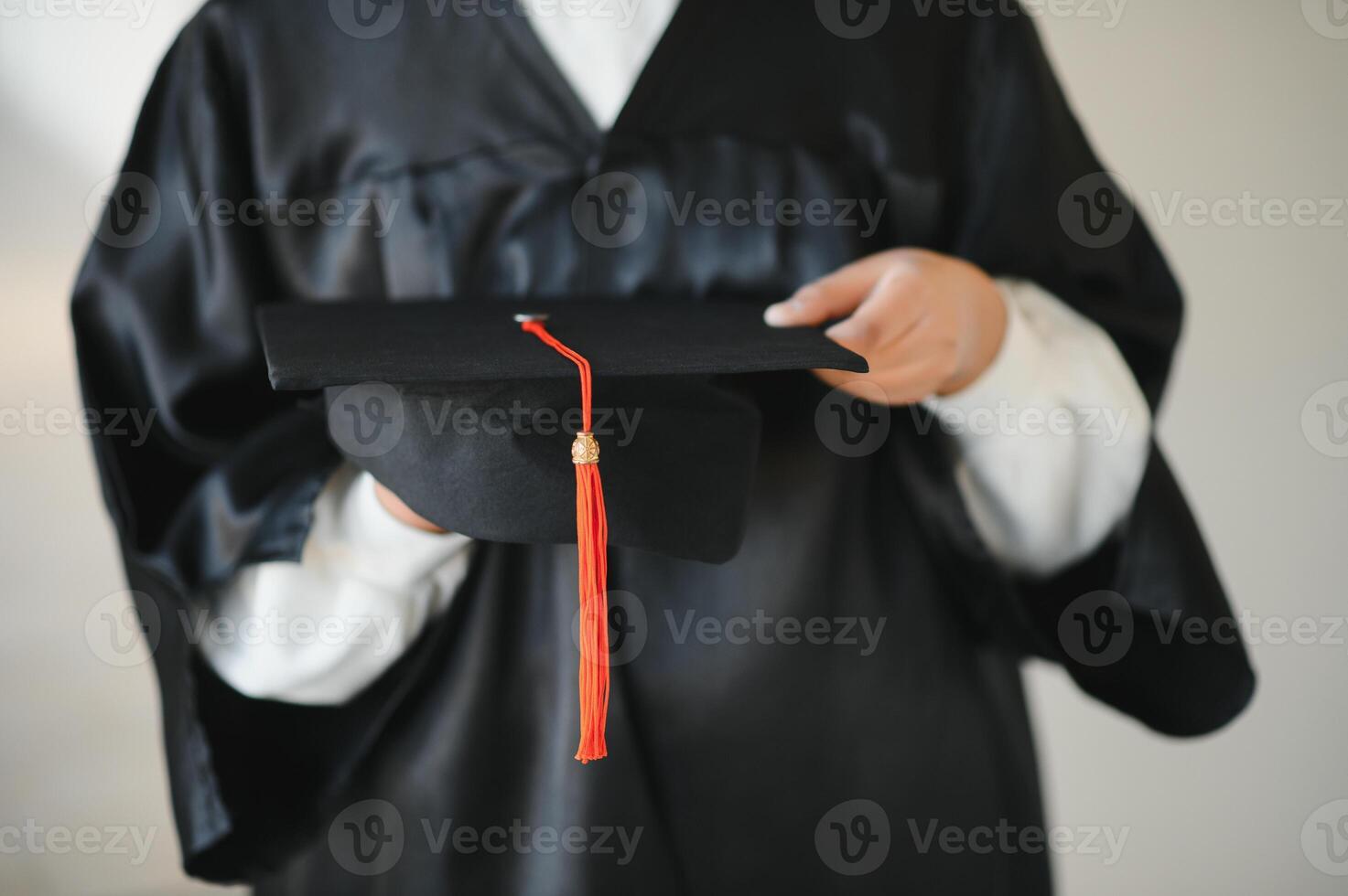 Happy Indian university student in graduation gown and cap holding diploma certificate. photo