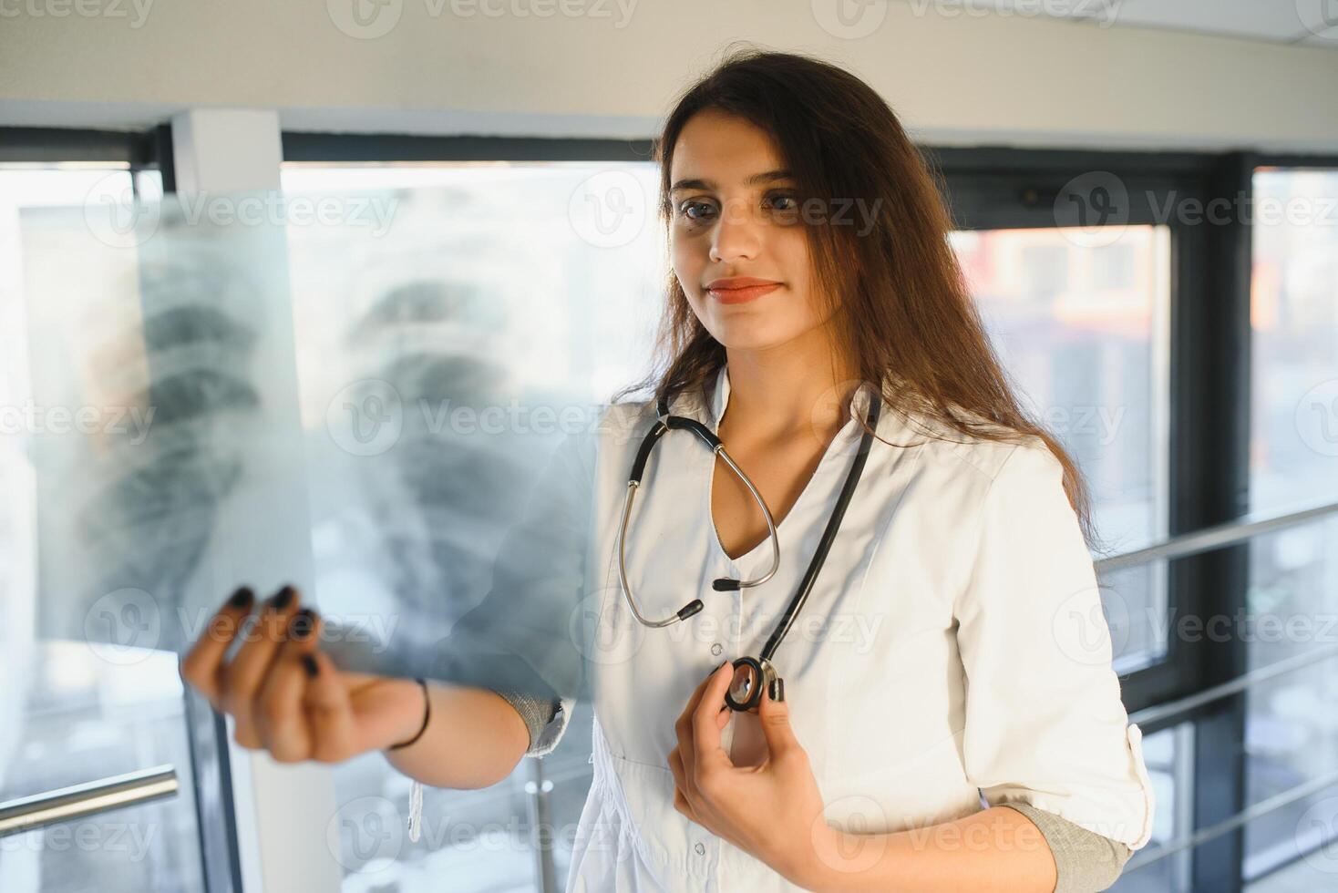 An Indian Asian female medical doctor in a hospital office with stethoscope. photo