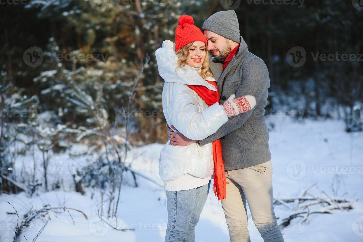 Winter picnic in the forest. Love story in snow. couple in winter play in snow and hugging near the pine. Two lovers on winter walk. Valentine's Day for couple in rustic style. Winter lovestory photo