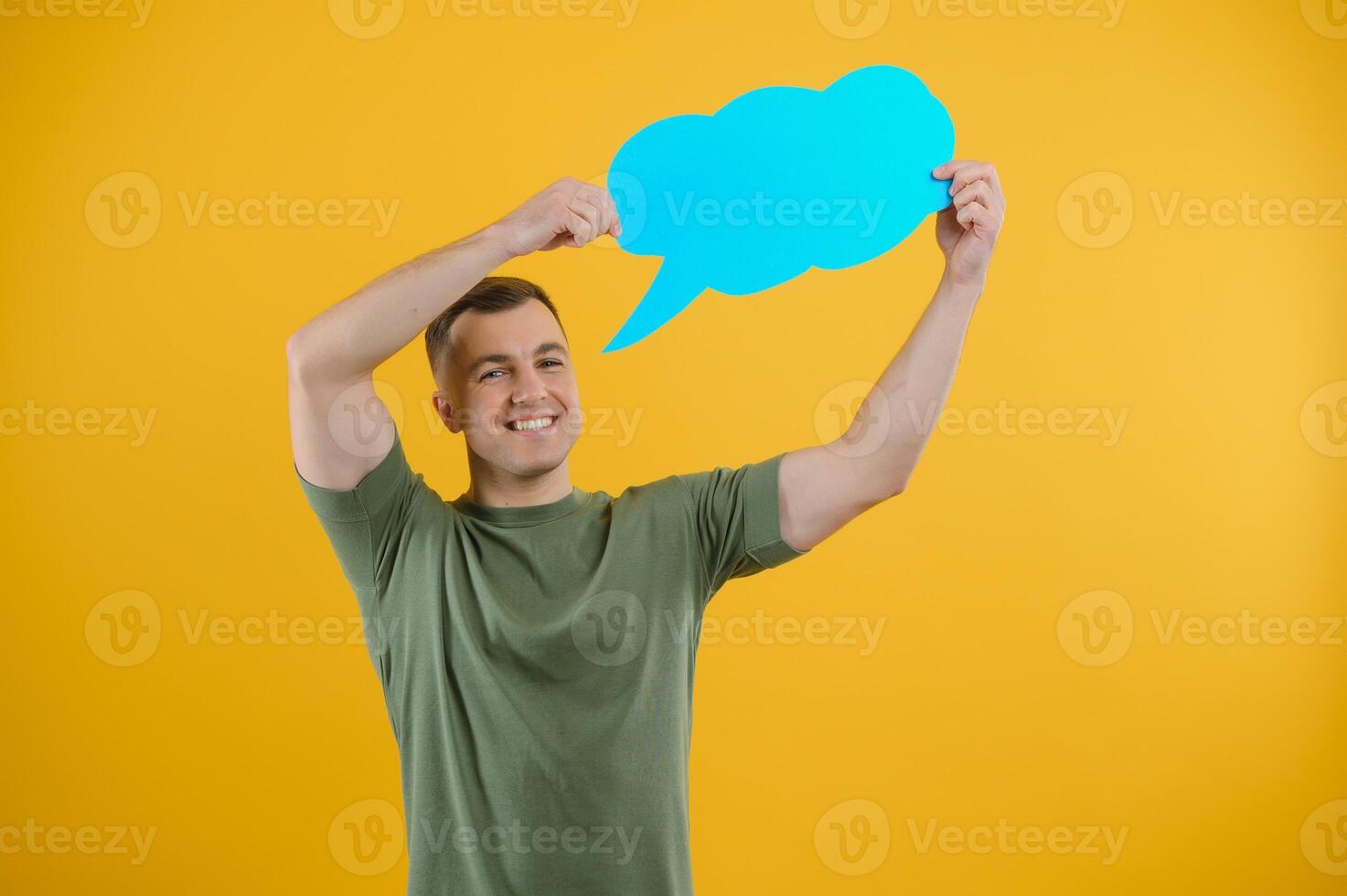 Young caucasian man isolated on yellow background holding a thinking speech bubble and doing OK sign photo