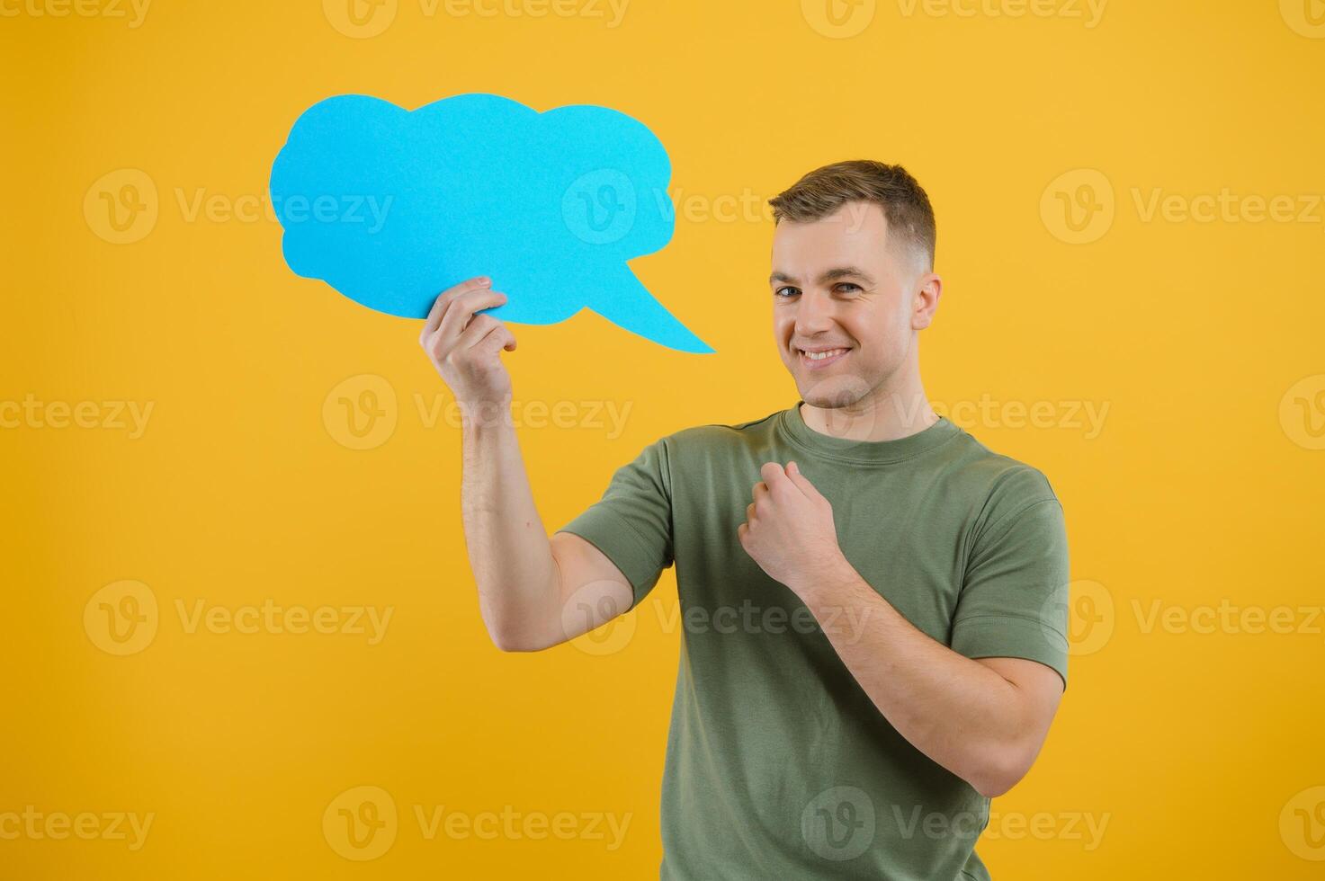 Young caucasian man isolated on yellow background holding a thinking speech bubble and doing OK sign photo