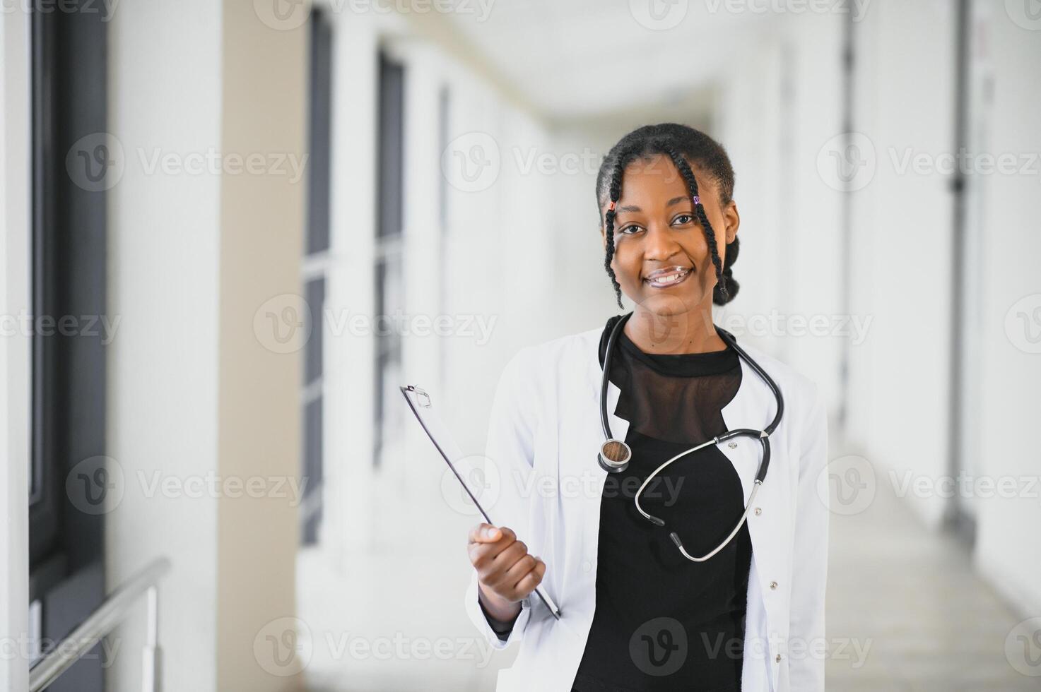african american female doctor in hospital corridor photo