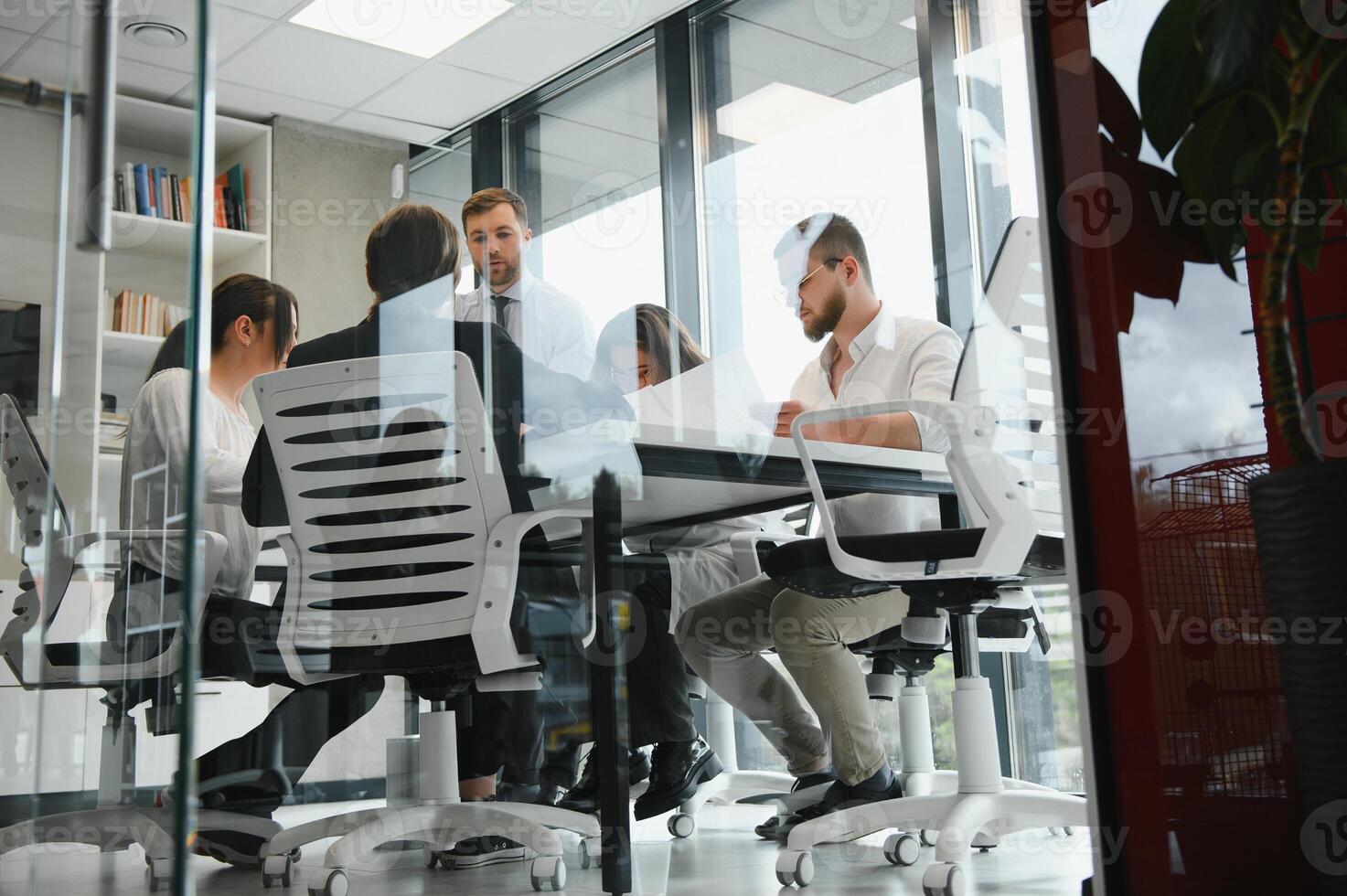 Corporate business team and manager in a meeting room at modern office with panoramic windows. Business concept photo