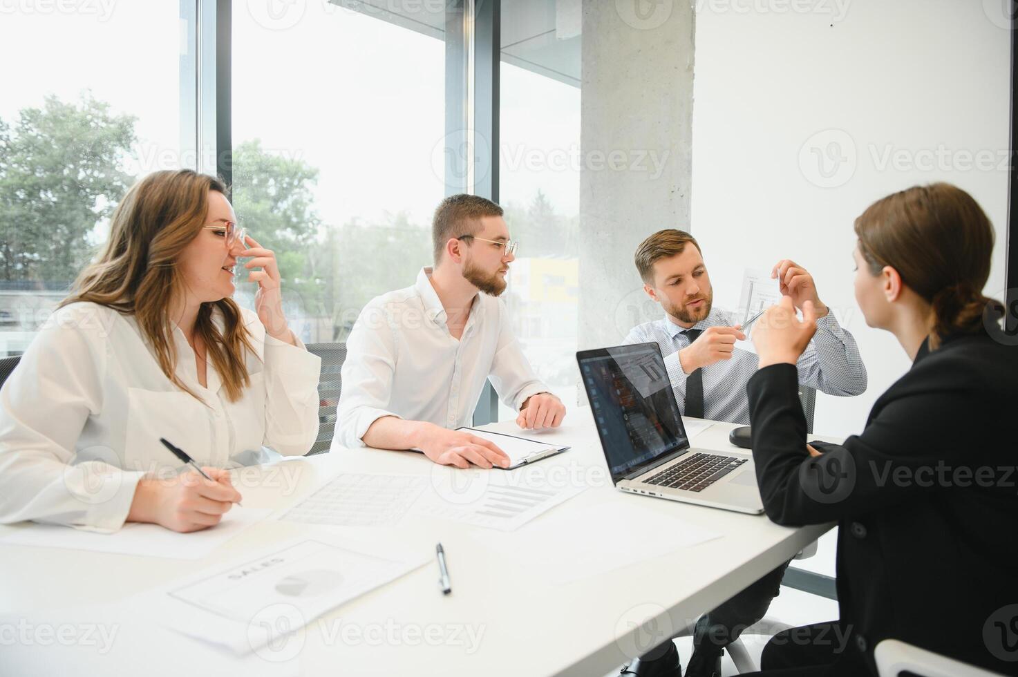 Group of businessmen and businesswomen stock brokers working at office. photo