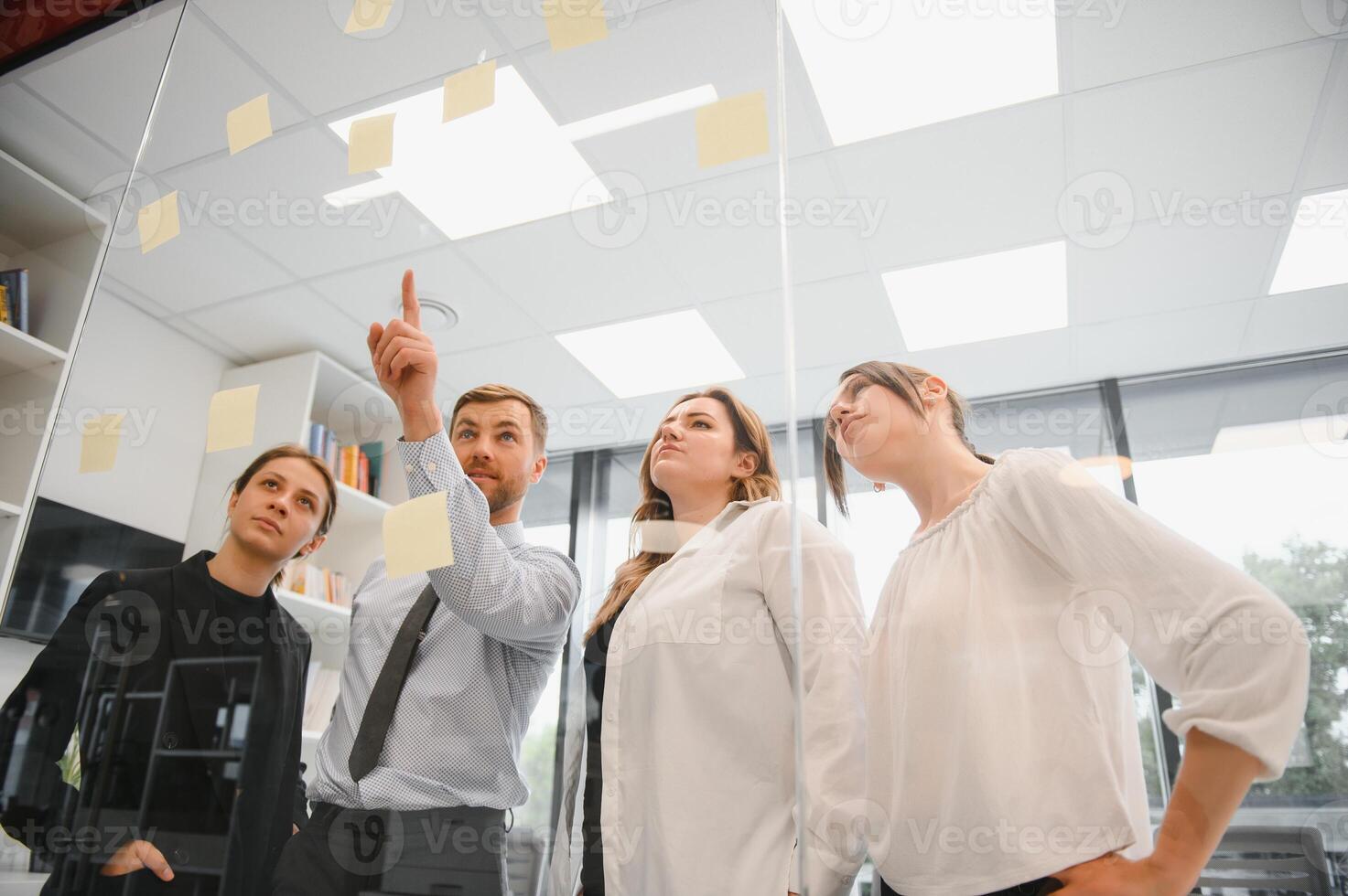 Corporate business team and manager in a meeting room at modern office with panoramic windows. Business concept photo