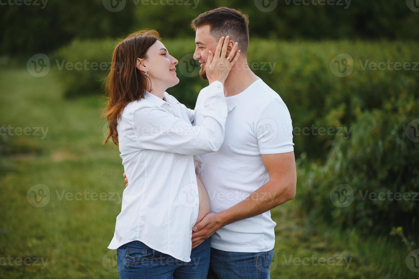 Pregnant woman with her family looking happy photo