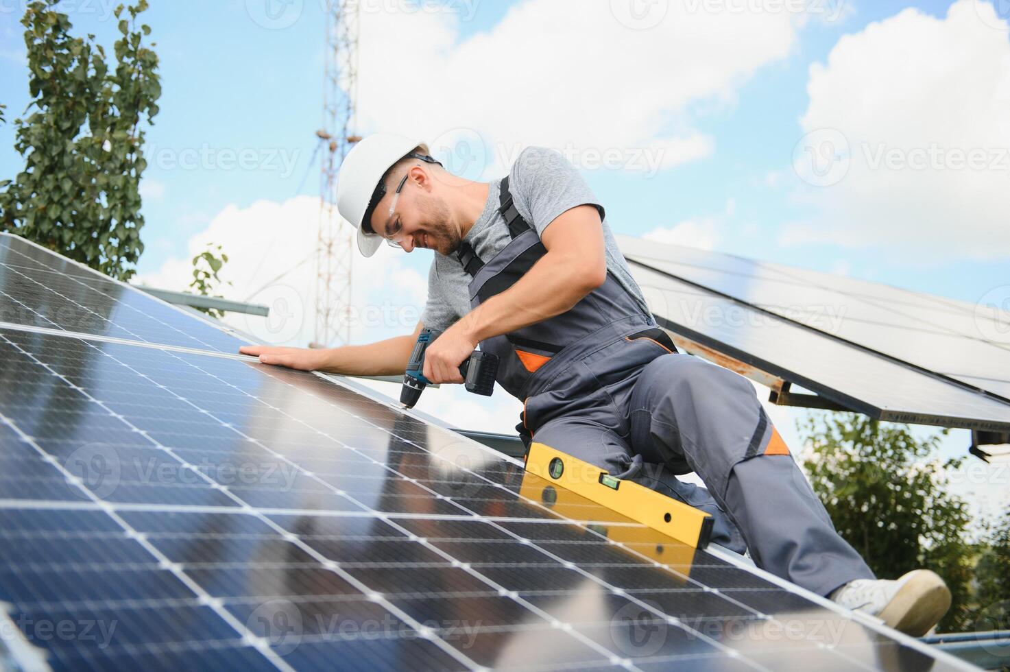 Worker installing solar panels outdoors photo