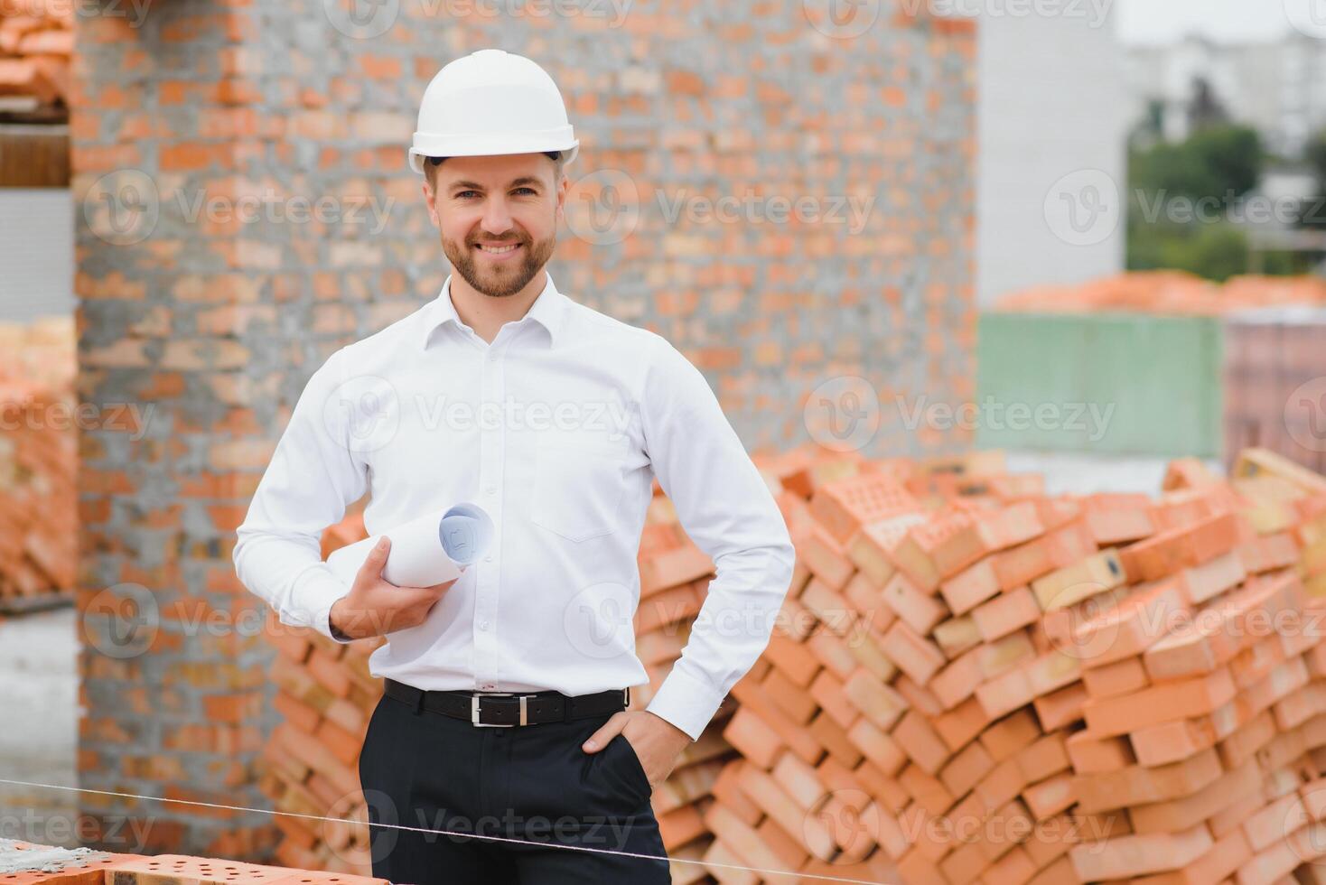 A construction worker controlling the construction of roof structures on construction site photo