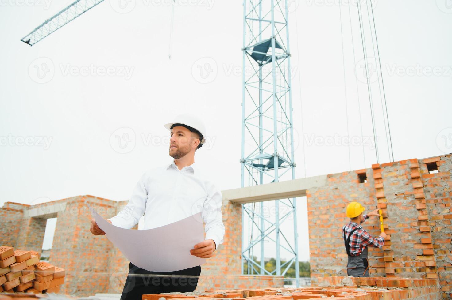 Engineering Consulting People on construction site holding blueprint in his hand. Building inspector. Construction site check drawing and business workflow of new building. photo