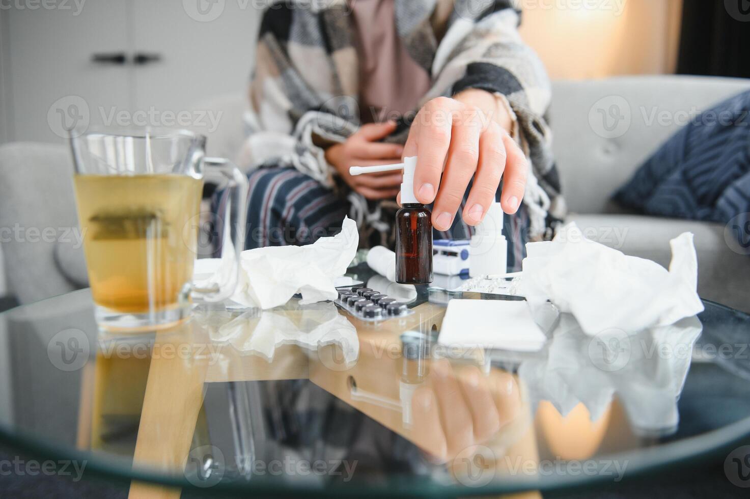 Close-up man's hands holds white plastic bottle with pills and ready to take supplement pill with glass of water. Ill man taking medication. Sick person need medicine against a headache and cold photo