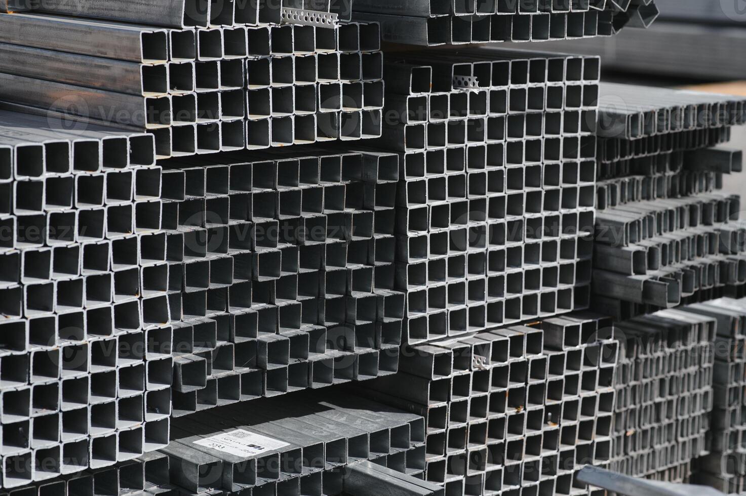Stack of rolled metal products, perspective view of steel pipes of rectangular cross-section photo