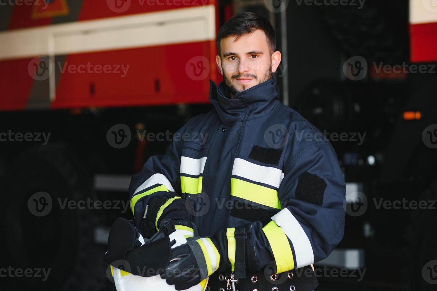 Photo of fireman with gas mask and helmet near fire engine