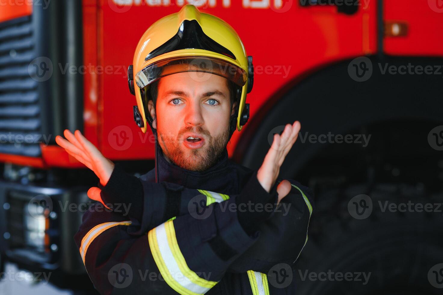 Fireman firefighter in action standing near a firetruck. Emergency safety. Protection, rescue from danger. photo