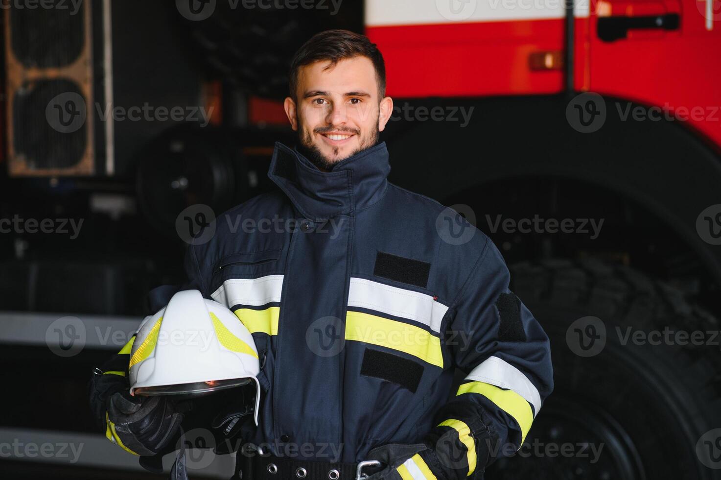Photo of fireman with gas mask and helmet near fire engine