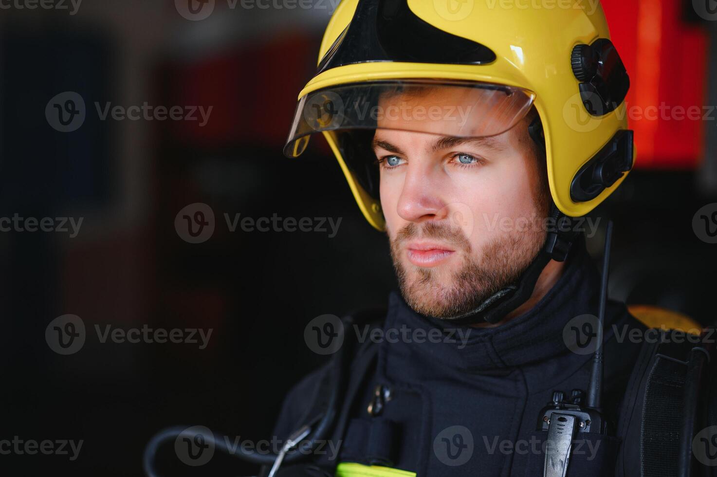 Photo of fireman with gas mask and helmet near fire engine