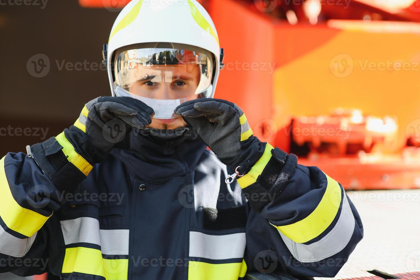 Photo of fireman with gas mask and helmet near fire engine