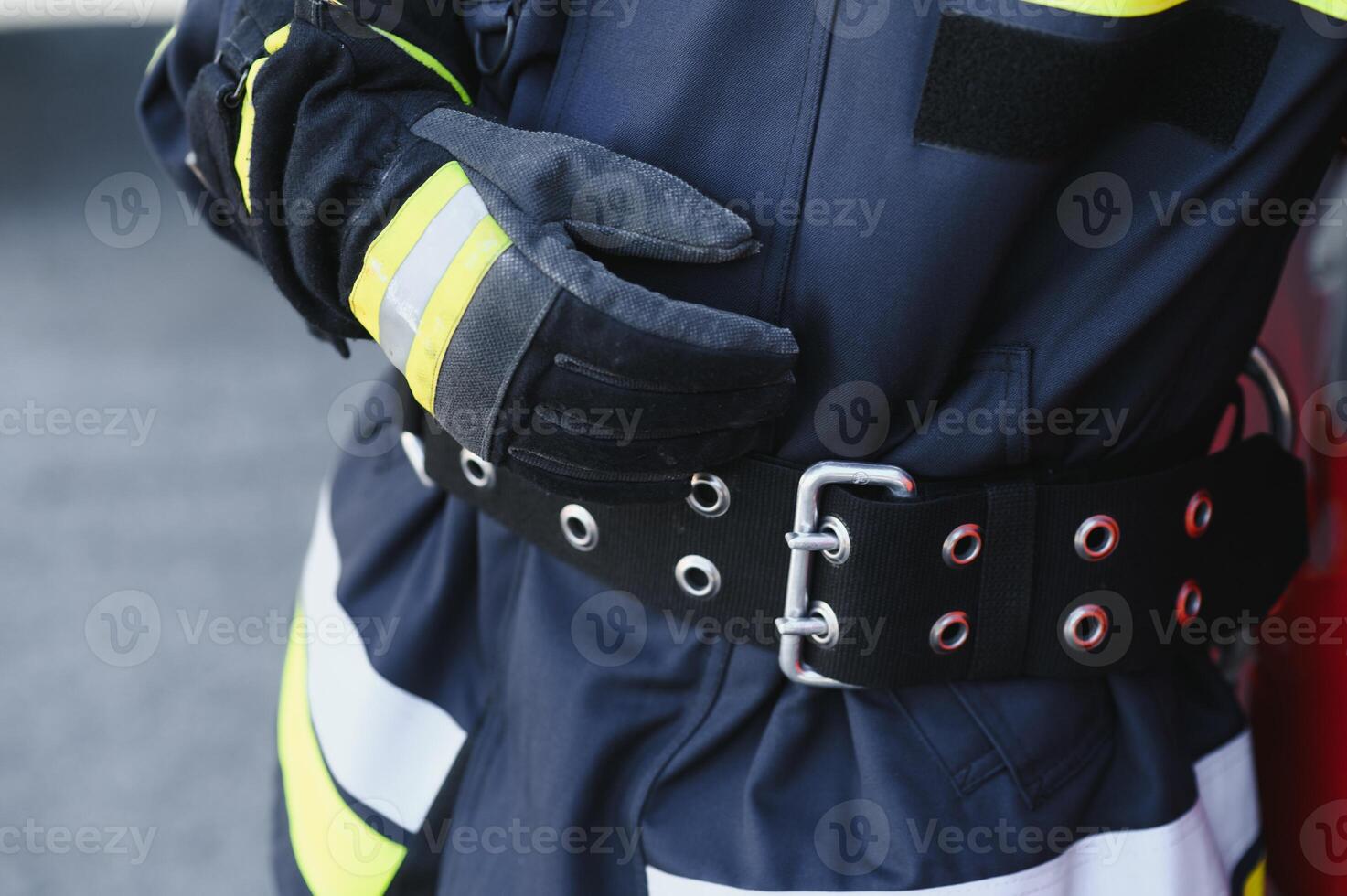 Fireman firefighter in action standing near a firetruck. Emergency safety. Protection, rescue from danger. photo