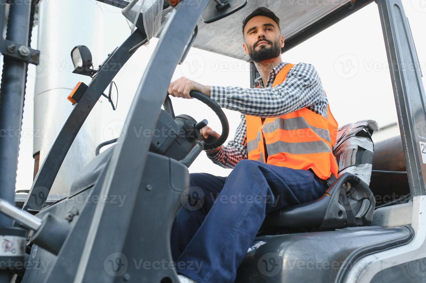 Waving forklift driver in the warehouse of a haulage company while driving forklift photo