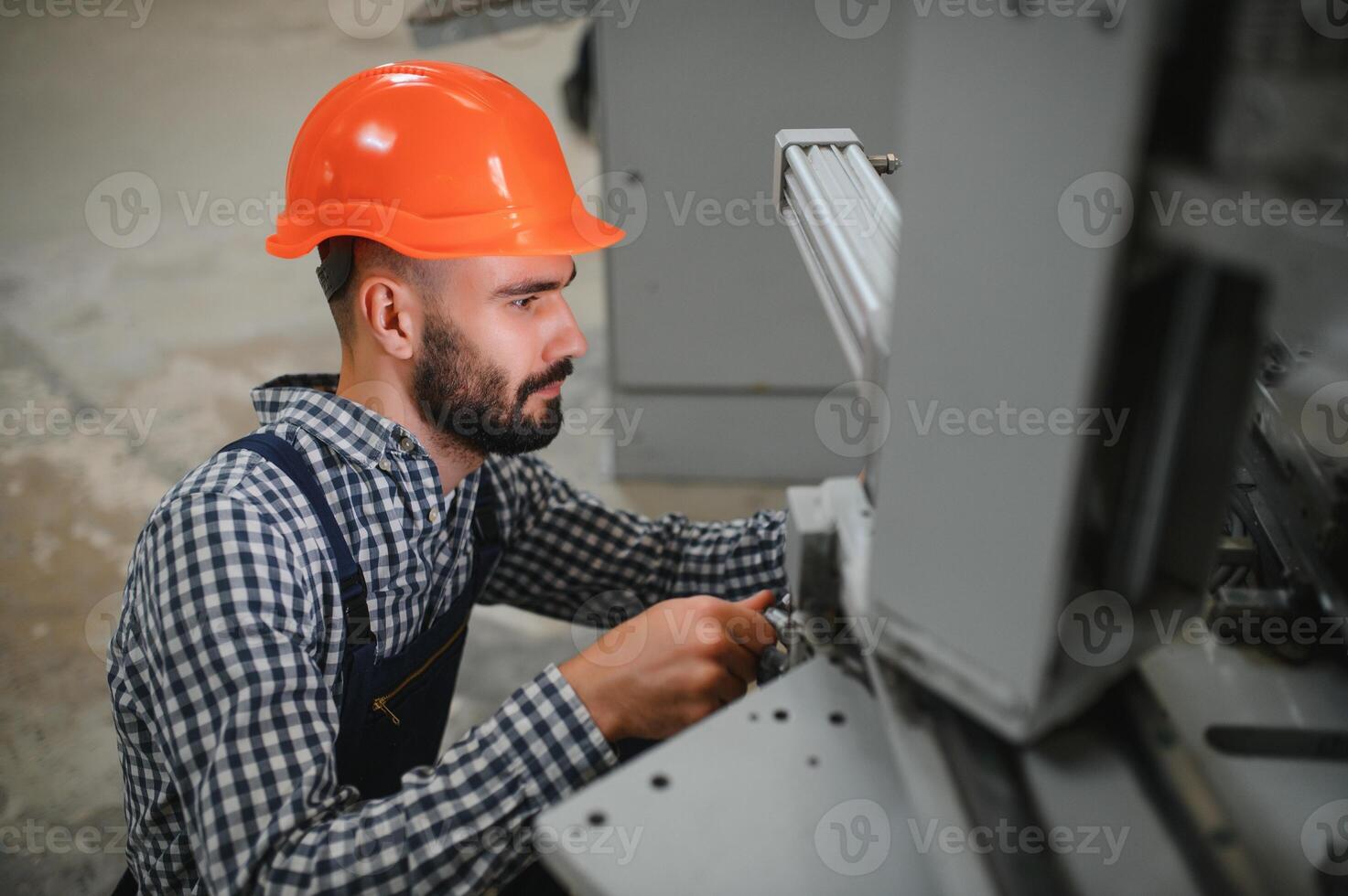 modern industrial machine operator working in factory photo