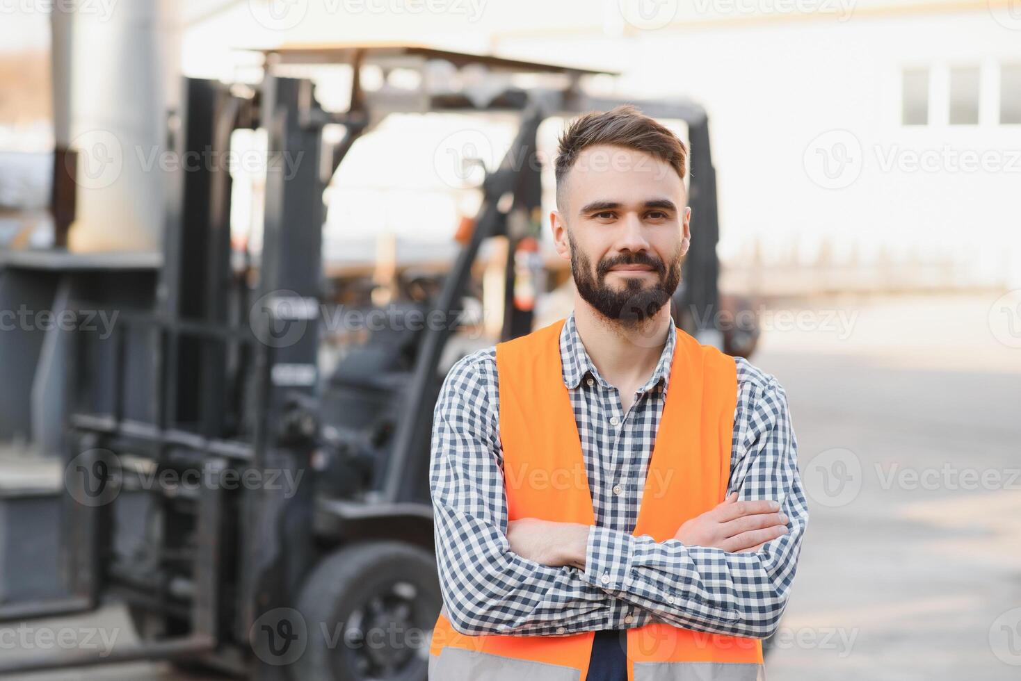 Waving forklift driver in the warehouse of a haulage company while driving forklift photo