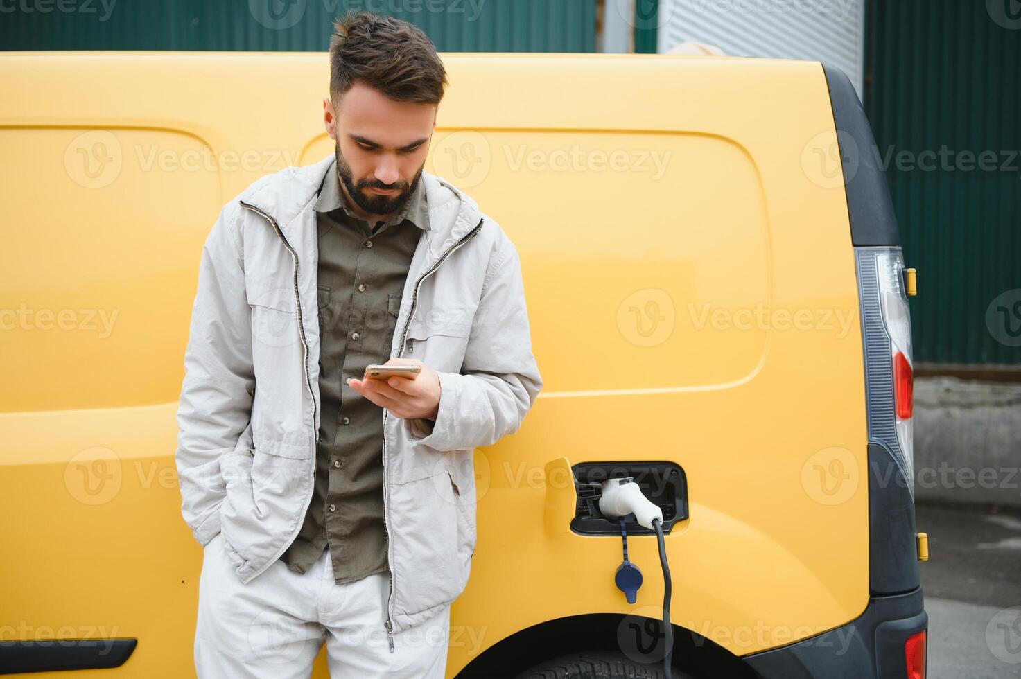 Man charging his electric car. photo