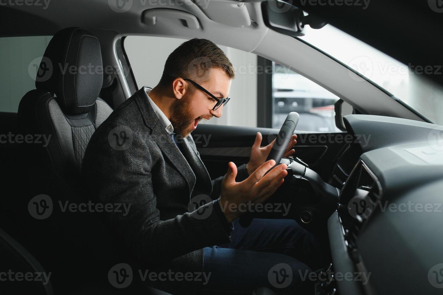 His true love. Portrait of a mature man smiling happily sitting in a brand new car photo