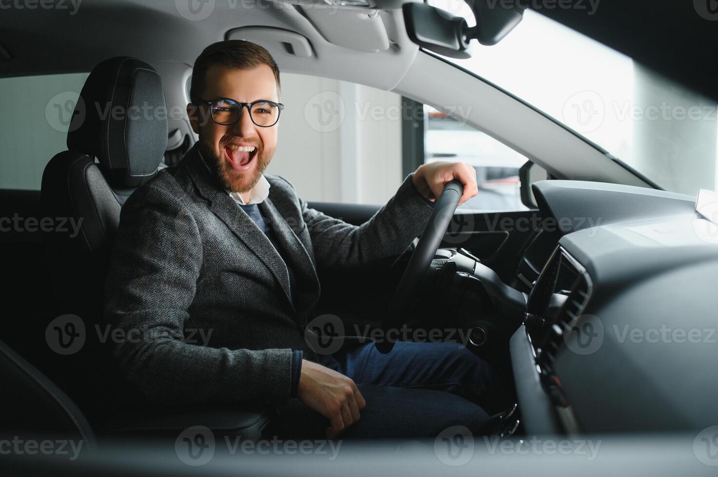 His true love. Portrait of a mature man smiling happily sitting in a brand new car photo