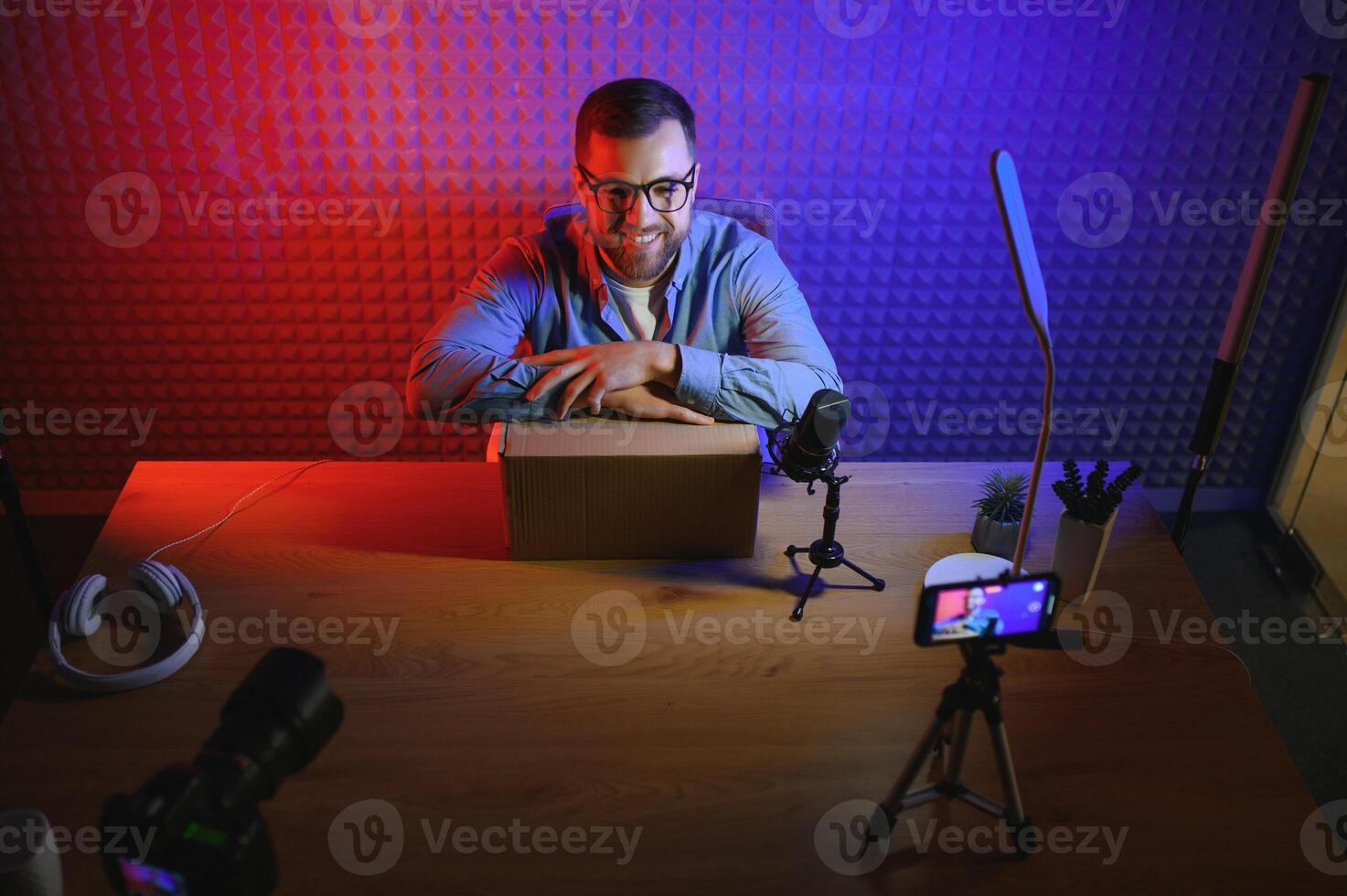 A blogger records content in his studio. The backstage photo was taken from behind one of the participants in the shooting, at the beginning of the shooting when the blogger is preparing.
