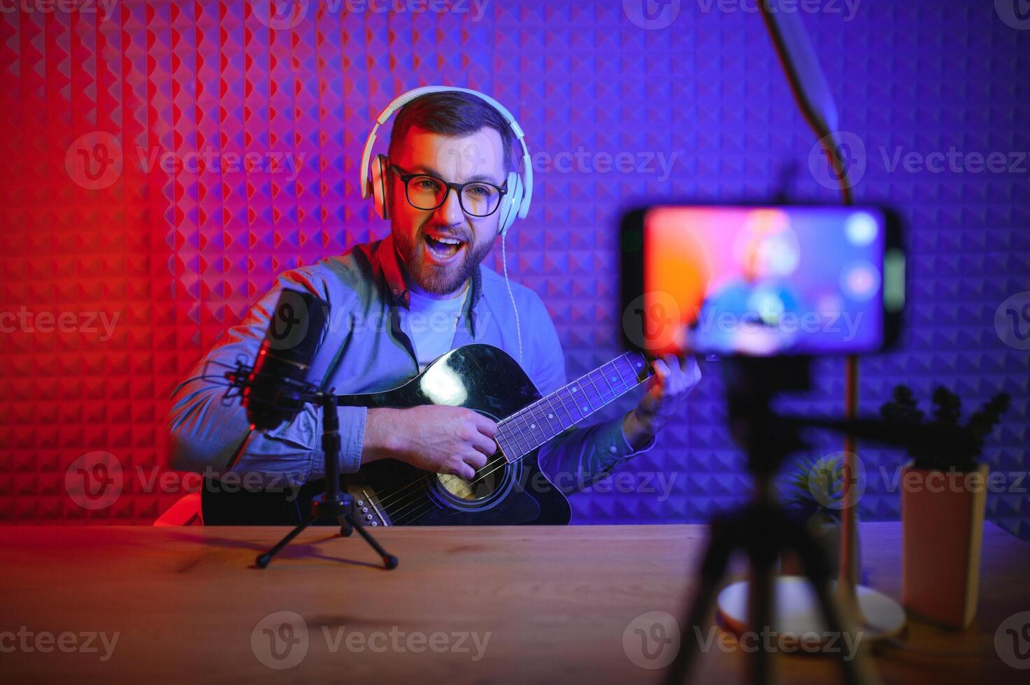 Male vlogger recording music related broadcast at studio photo