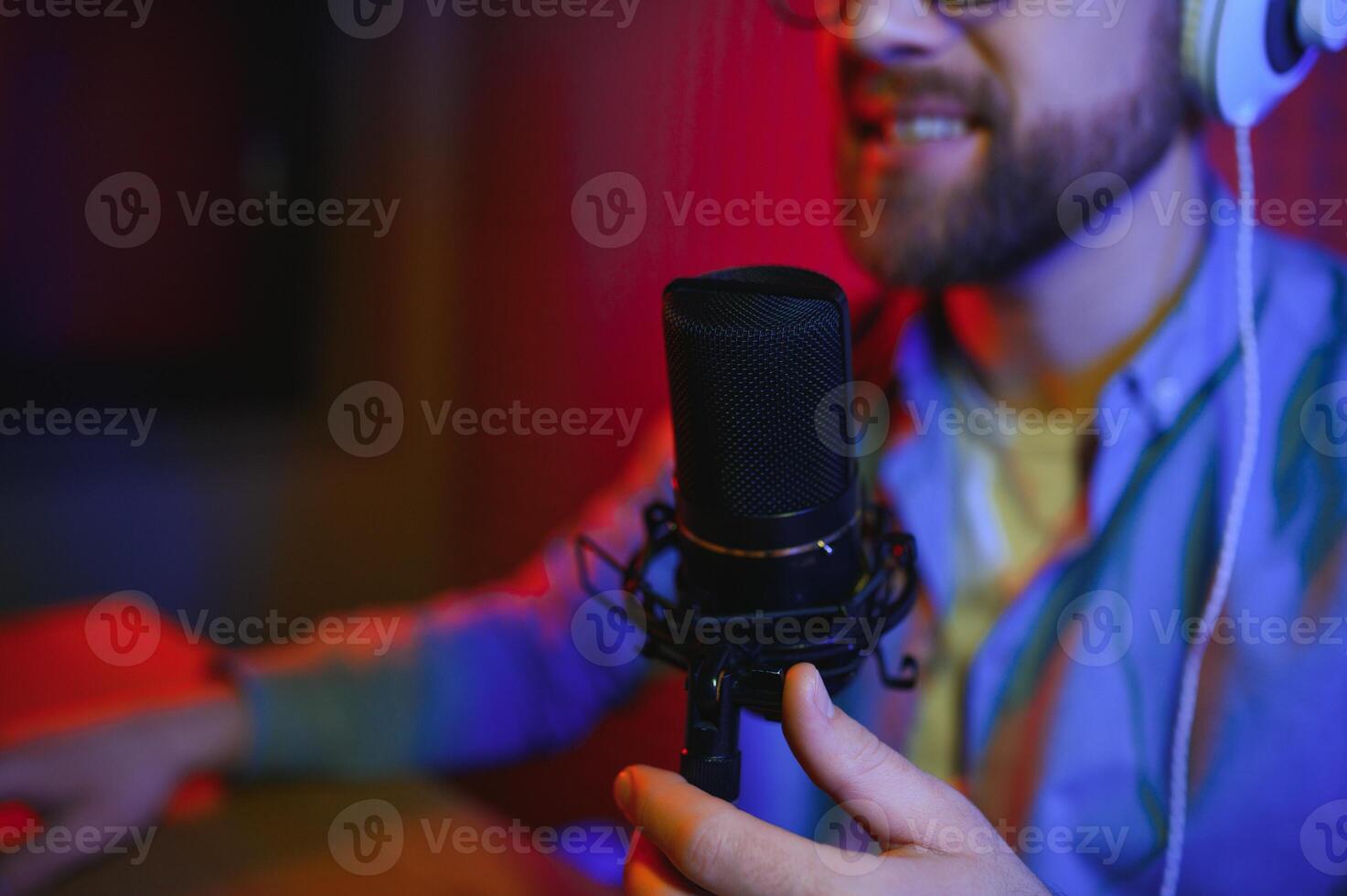 A blogger records content in his studio. The host of the blog is a young man who is very enthusiastic about telling his subscribers a story. photo