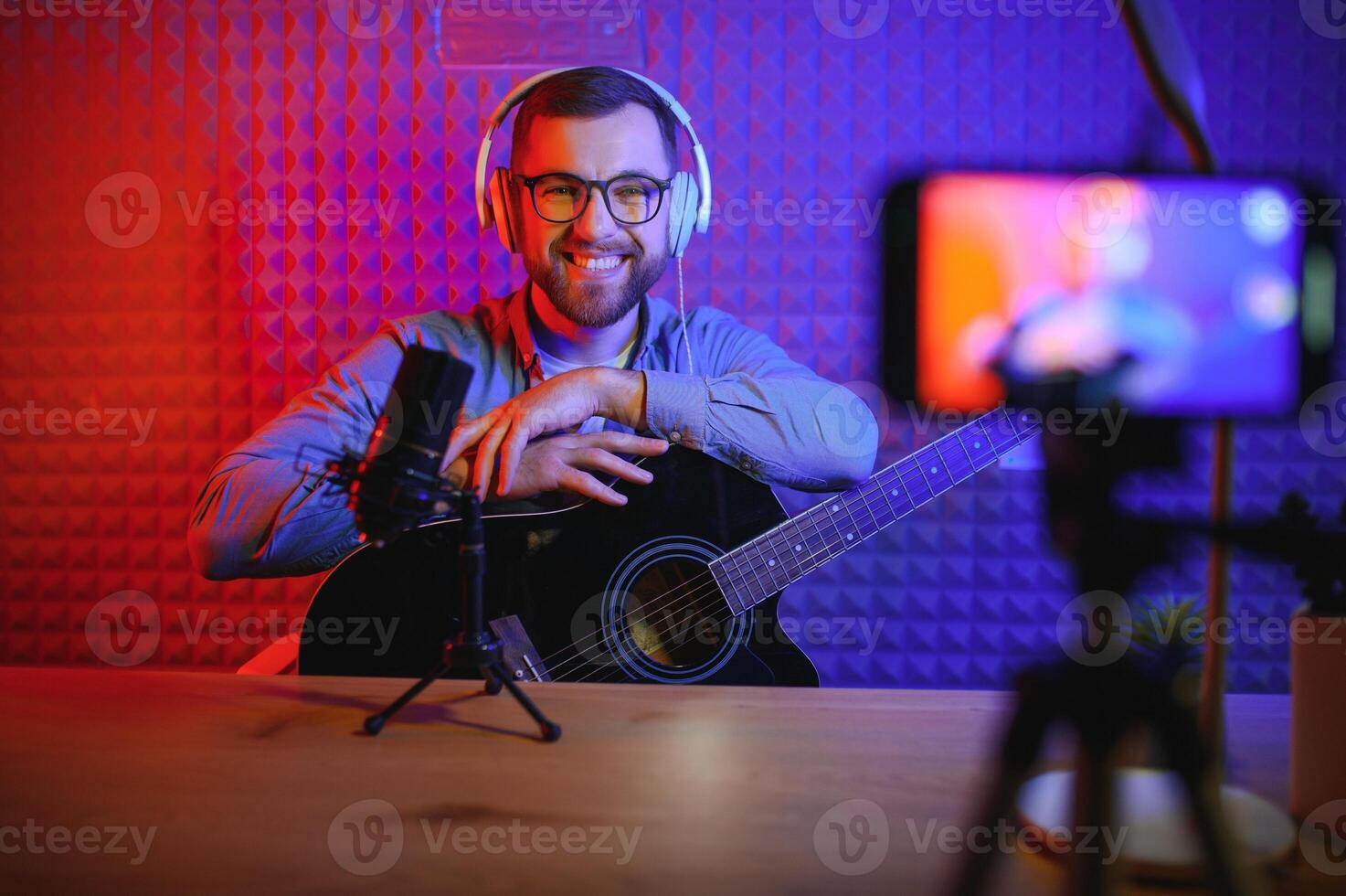 Male vlogger recording music related broadcast at studio photo