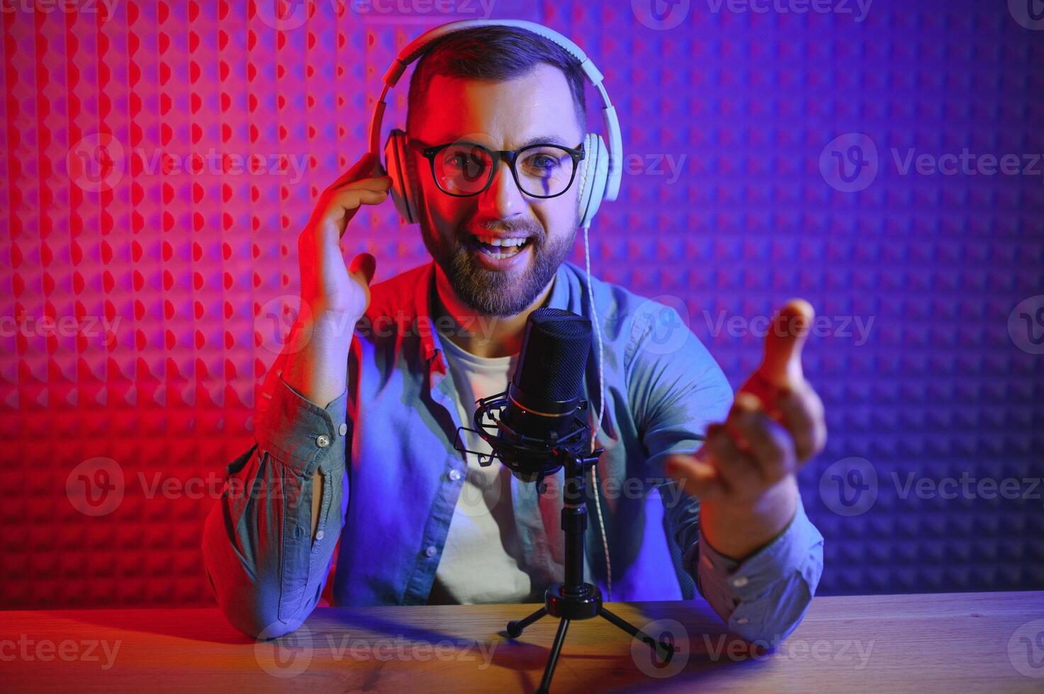 A blogger records content in his studio. The backstage photo was taken from behind one of the participants in the shooting, at the beginning of the shooting when the blogger is preparing.