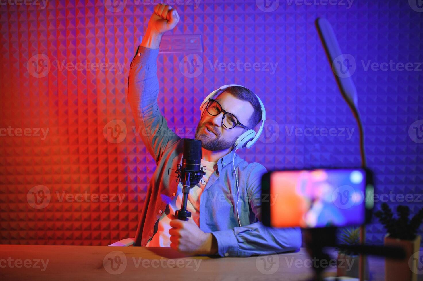 A blogger records content in his studio. The backstage photo was taken from behind one of the participants in the shooting, at the beginning of the shooting when the blogger is preparing.
