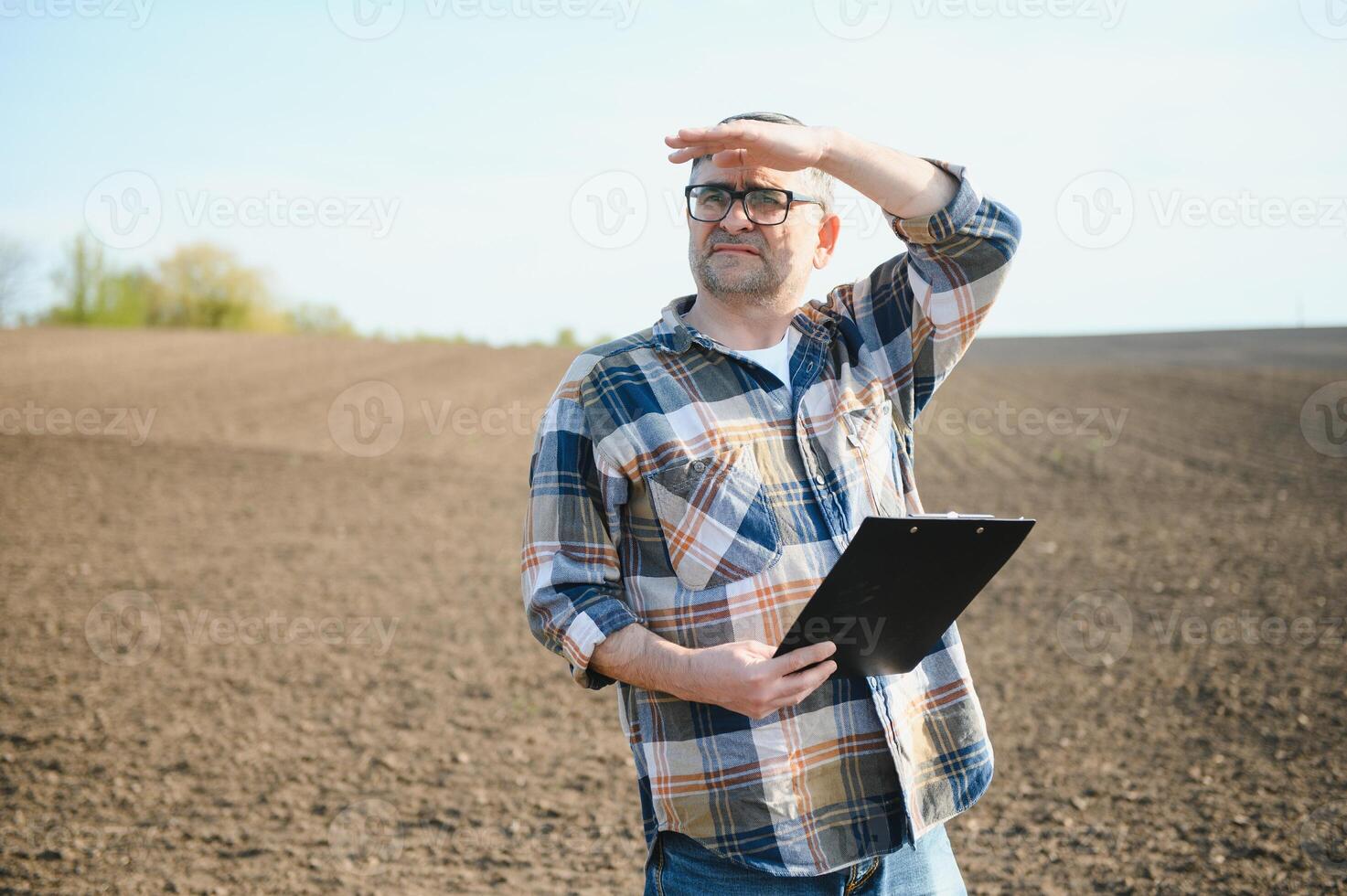 A farmer checks quality of soil before sowing. photo