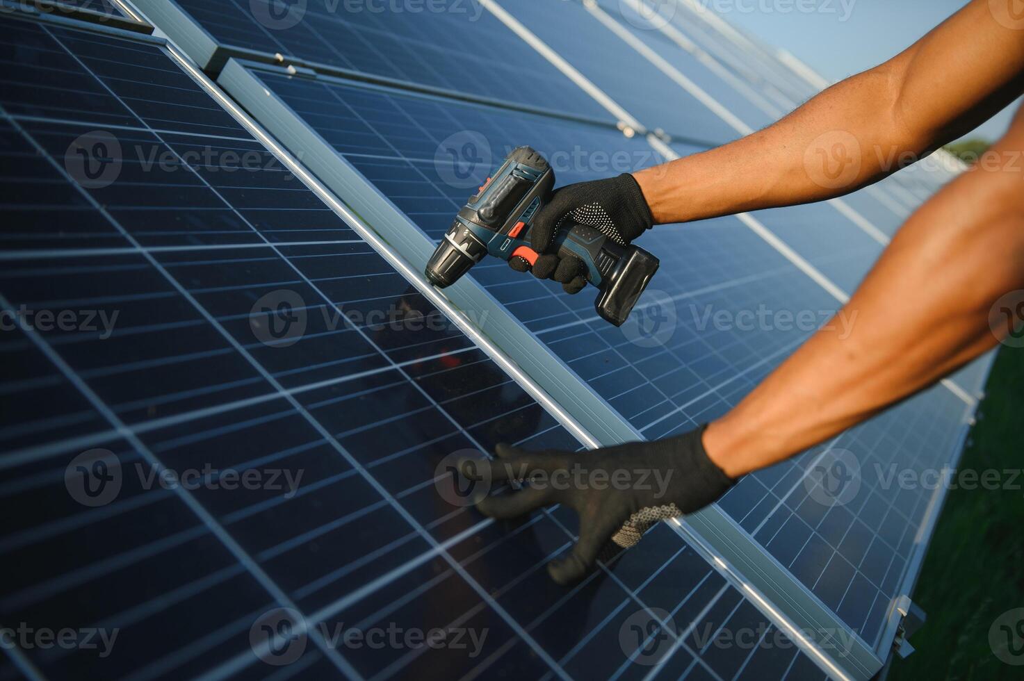 close-up of worker's hands installing solar panels photo