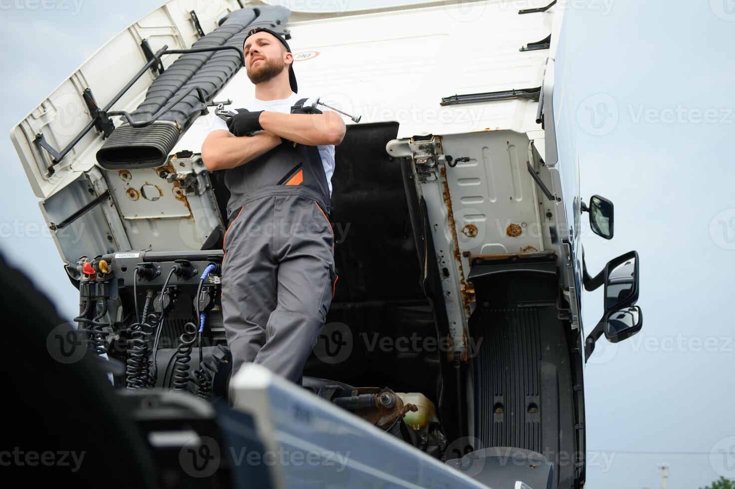 Professional truck mechanic working in vehicle repair service. photo