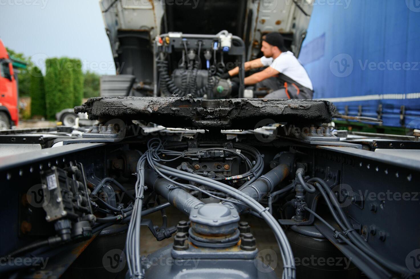 Professional truck mechanic working in vehicle repair service. photo